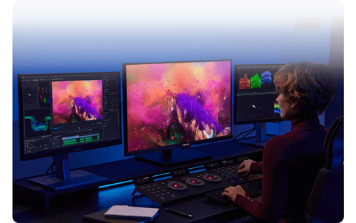 Video editor working at ProArt Monitor workstation with DaVinci Resolve