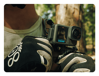 someone holding a GoPro camera connected to the contacto