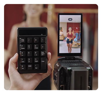 someone controlling the streaming camera using a mini keyboard