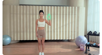 image of fitness instructor holding hand up infront of exercise space