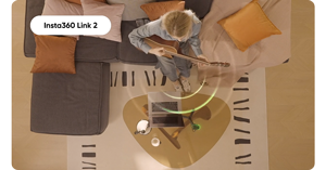 top down image of person playing guitar sat on couch in living room