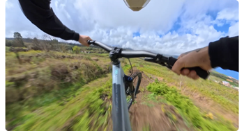 pov image from downhill mountain bike rider going over jump