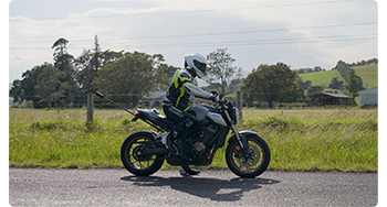 Rider sitting on super bike with insta360 x5 attached on extension pole