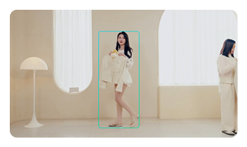 OBSBOT Tail 2 AI-powered camera tracking a woman holding clothes