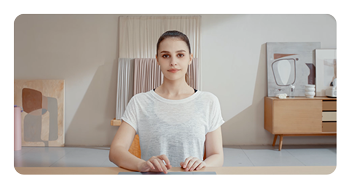 a woman sat at a desk with the OBSBOT Tiny 2 Lite AI-powered webcam