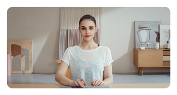 example image of a woman sat a desk with beauty mode activated on the OBSBOT Tiny 2 Lite AI-powered webcam