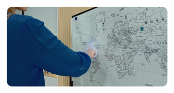 someone pointing to a map with their hand highlighted blue to showing hand tracking features of the OBSBOT Tiny 2 Lite PTZ webcam