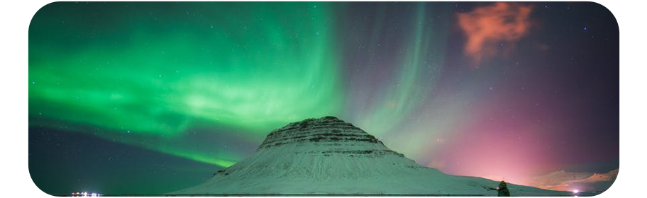 Sony a7 III sample image of snow covered mountain at night with the northern lights aurora borealus above in the sky