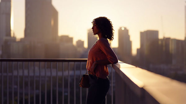 sample image of a woman overlooking a city taken with the Sony Alpha 6700