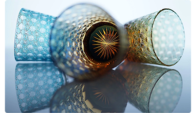 Sony FE 35mm F1.4 G Master Lens sample image of blue diamond cut crystal tumbler glasses laying on their sides with the centre glass open to the camera with a golden star at the base