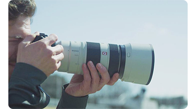 photographer using Sony FE 100-400mm G Master Lens to capture sports photography
