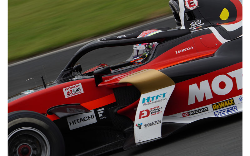 Sony FE 200-600mm F5.6-6.3 G OSS Lens sample photo of honda formula dream race car with red black and white Motul Honda Mugen colours close up on cockpit and driver as it goes round track