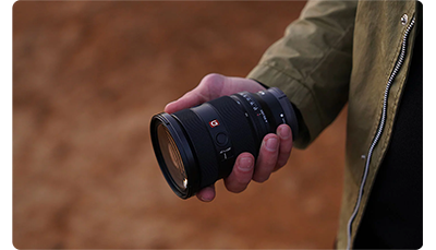 photographer holding Sony FE 24-70mm F2.8 GM II Lens