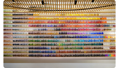 Sony FE 24-70mm F2.8 GM II Lens sample image of multi coloured jars on floor to ceilings wooden shelves with