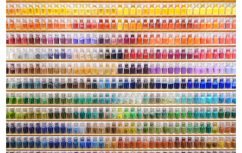 Sony FE 24-70mm F2.8 GM II Lens sample image of multi coloured jars on floor to ceilings wooden shelves with