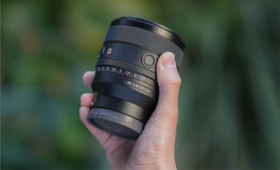 somoene holding the sony e mount lens