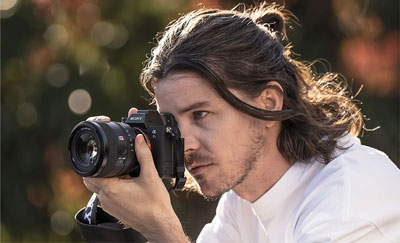 someone taking a photo using the sony e mount lens
