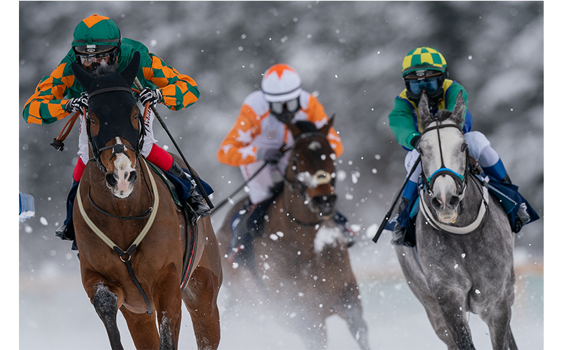 Sony FE 600mm F4 G Master OSS Lens sample image of horse racing in the snow with three horses with jockies one after the other facing to camera