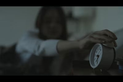 sample image of a woman turning off her alarm clock taken with the Sony FX2