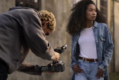 someone filming a woman walking through woodland using the Sony FX2