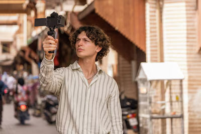 someone using the sony zv e10 ii with the grip