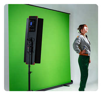 content creator stood in front of the swit green screen