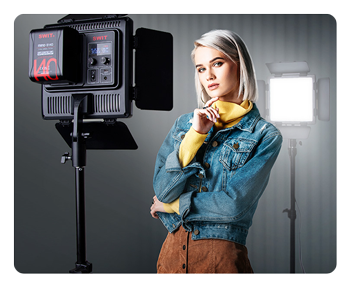 a woman stood in front of 2 of the swit panel lights