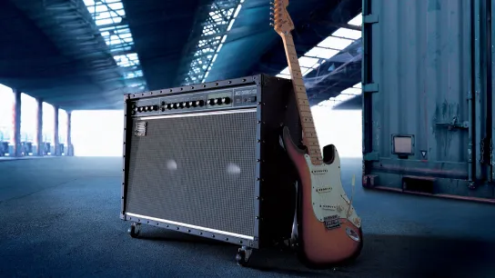 Electric guitar plugged into a guitar amplifier