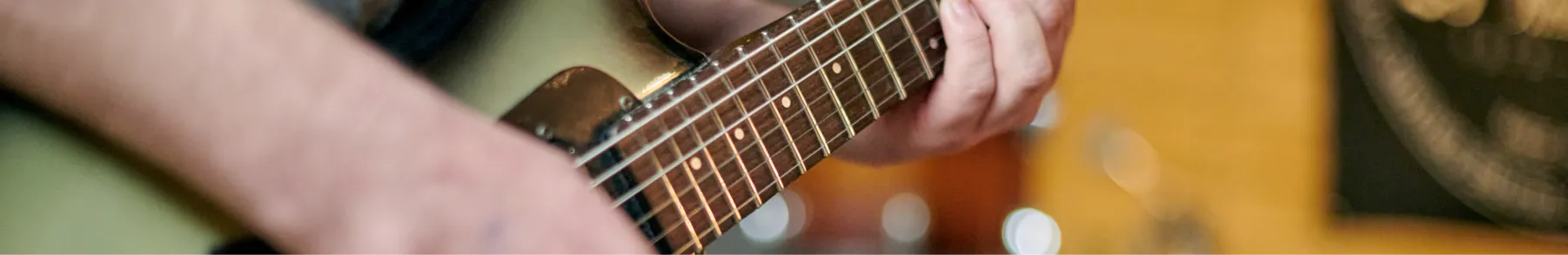 Guitarist standing with a guitar showing weight and balance