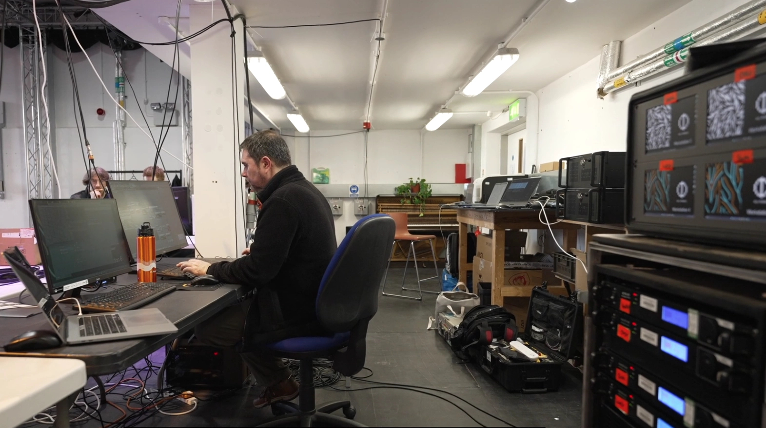 Hardware setup for LILITH.AEON showing technical equipment and workstations