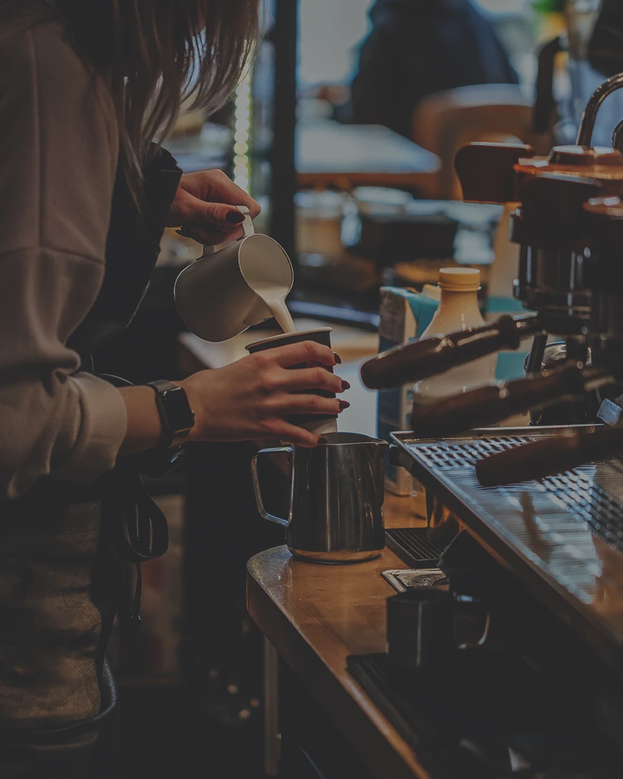 coffee shop pouring a cup of coffee