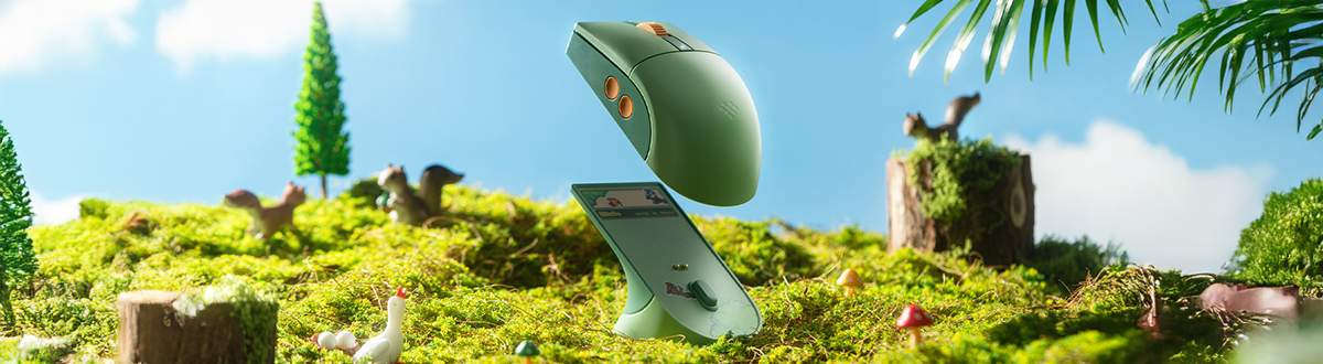 Multifunctional charging dock, R8 mouse hovering over the dock, grassy woodland background behind.