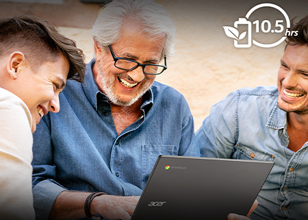 group of men smiling in front of laptop