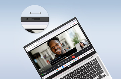 Close up image of the laptop webcam and next to it on screen a video call is taking place.