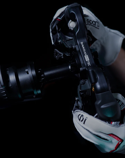 Hand turning a racing wheel connected to the BavarianSimTech spacer
