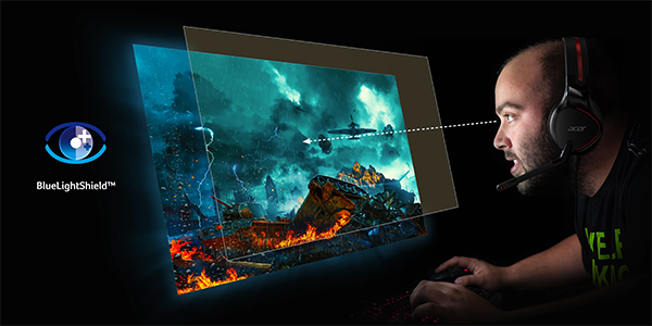 Image of a man using the monitor with a light shield overlay infront of it