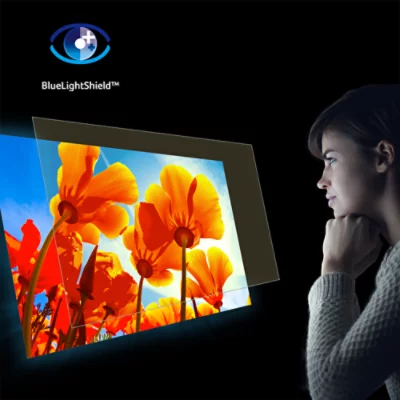 Woman in darkness looking at flower projection with BlueLightShield layer floating above the projection.