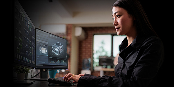 Developer working between two monitors to showcase productive workflow