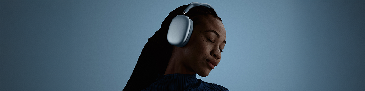 Person with eyes closed and head tilted, wearing AirPods Max 2 headphones.