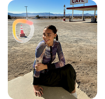 Photograph of a woman with a traffic cone highlighted in the background to be removed from the image