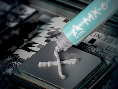CPU seated in a socket with MX-6 thermal paste being applied for optimal performance