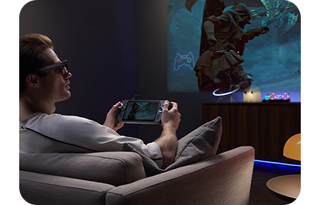 Lifestyle image of a man using the ROG XREAL R1 via a ROG ALLY Console