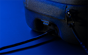 ROG Raikiri II in carry case with wire plugged into its rear charging port.