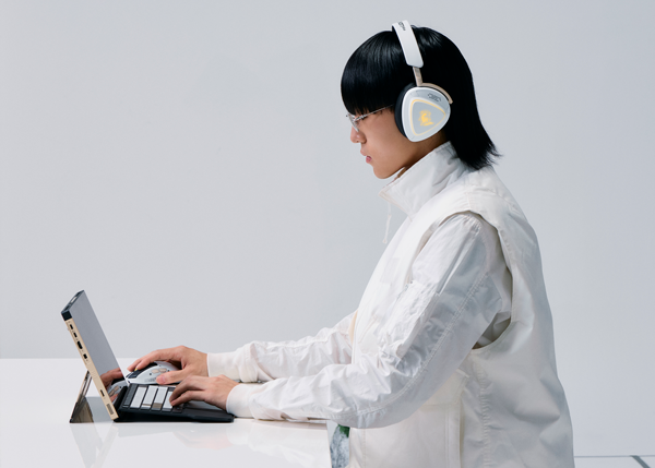 Model sat at desk using ASUS ROG Kojima Productions Limited Edition Peripherals with ASUS ROG Flow laptop