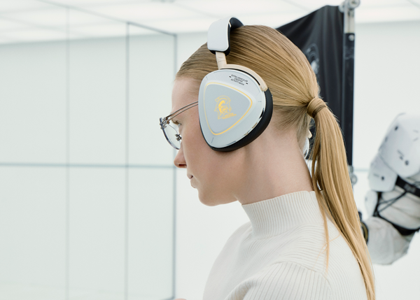 Model wears ASUS ROG Delta II with Kojima Productions mascot Ludens in background