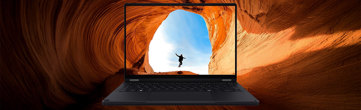 PX13 laptop displaying a person jumping on a bright opening from inside a sandy cavern.