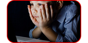 Image of a child looking closely at the laptop screen