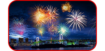 Landscape image of fireworks going off over a cityscape