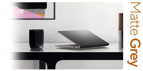 Matte grey Vivobook S16 on a desk in a home setting.