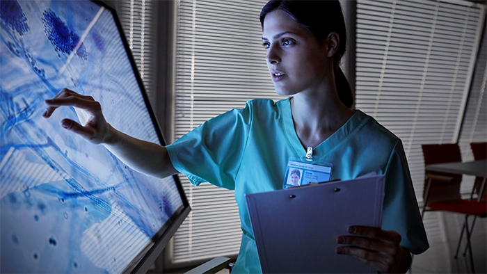 Nurse using a touchscreen monitor